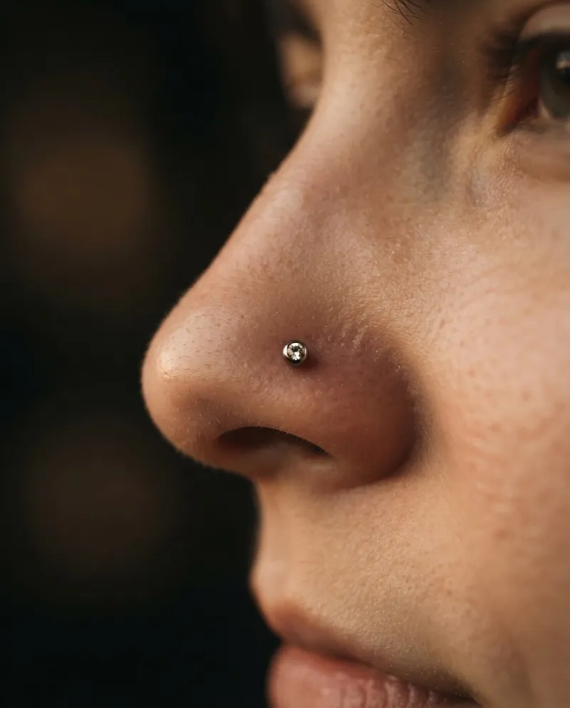 Pequeno piercing na narina com brinco de titânio